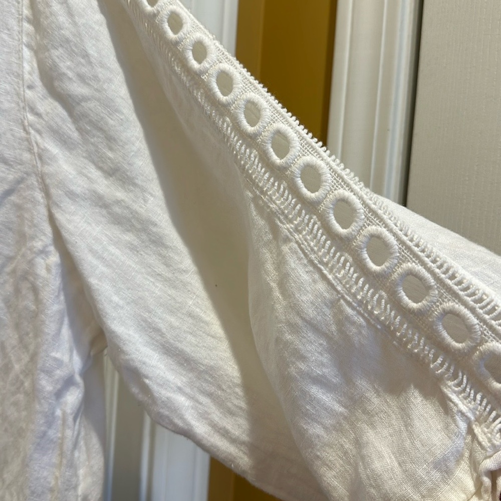 All white linen shirt with Decorative sleeves.